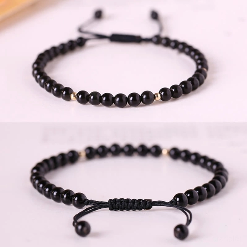 Two styles of black obsidian red string bracelets with adjustable pull cord closures, flat lay comparison