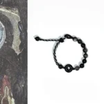 Black obsidian peace buckle bracelet with adjustable braided rope, flat lay overhead view on vintage stone texture background