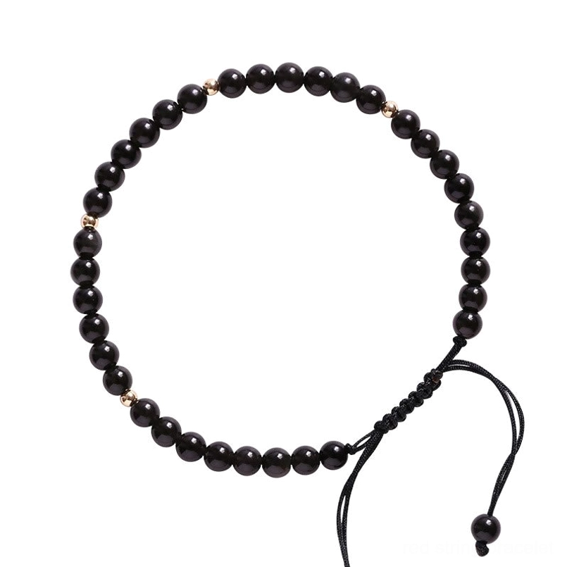 Black obsidian red string bracelet lifestyle product shot, grounding and protection talisman