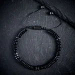 Black Obsidian flat bead protection bracelet with adjustable string and stainless steel clasp - flat lay view
