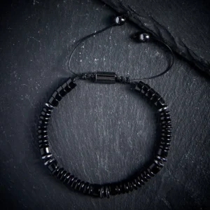 Black Obsidian flat bead protection bracelet with adjustable string and stainless steel clasp - flat lay view