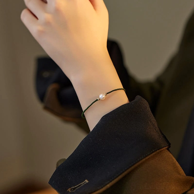 Black pearl string bracelet detail view gold accent beads natural pearl center