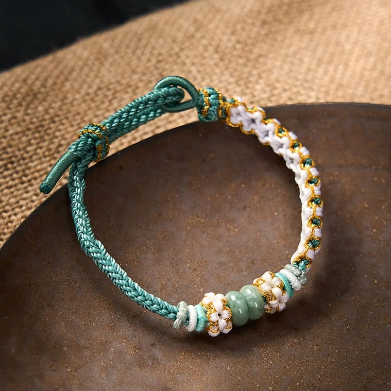 Black luck bracelet with protective jade beads and adjustable knot closure