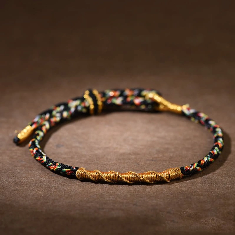 Black Rooster Acalanatha red string bracelet detail shot