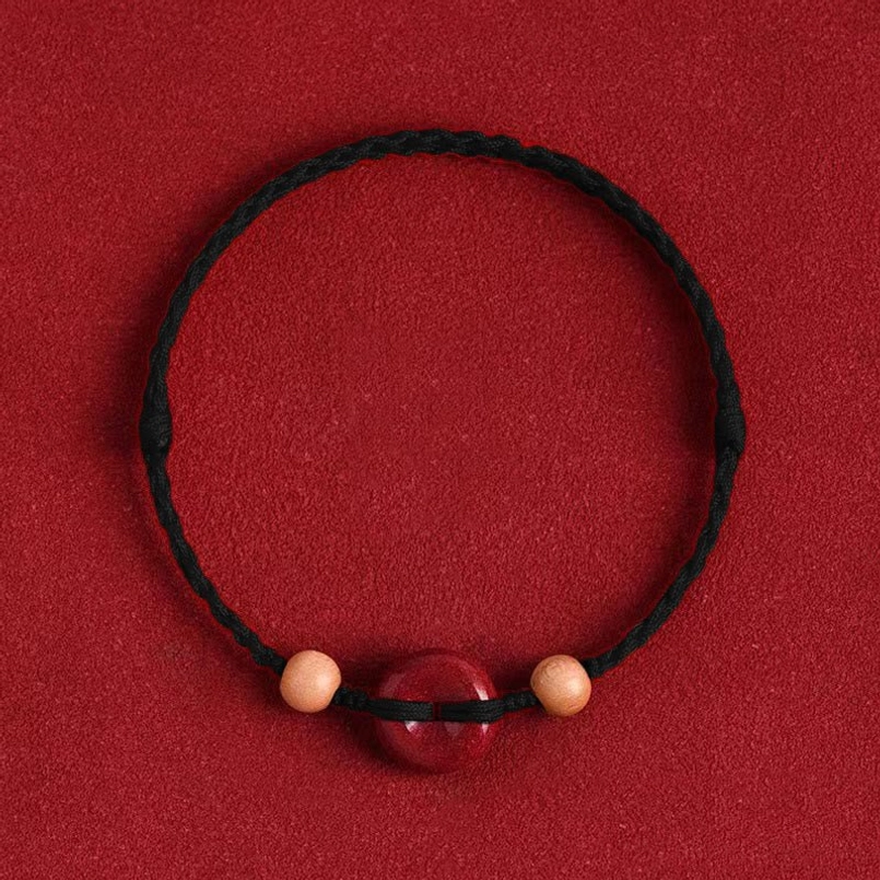 Black woven cord peach wood cinnabar bracelet with protective beads