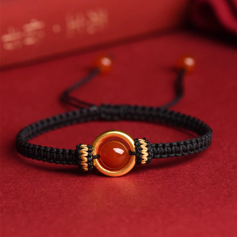 Black Braided Rope Red Agate Peace Buckle Bracelet Close Up On Red Fabric