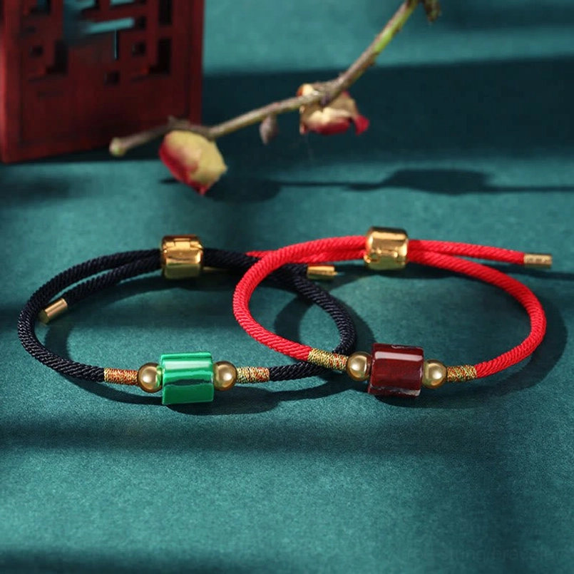Black rope Tibetan braided protection bracelet with green aventurine bead and gold metal accents