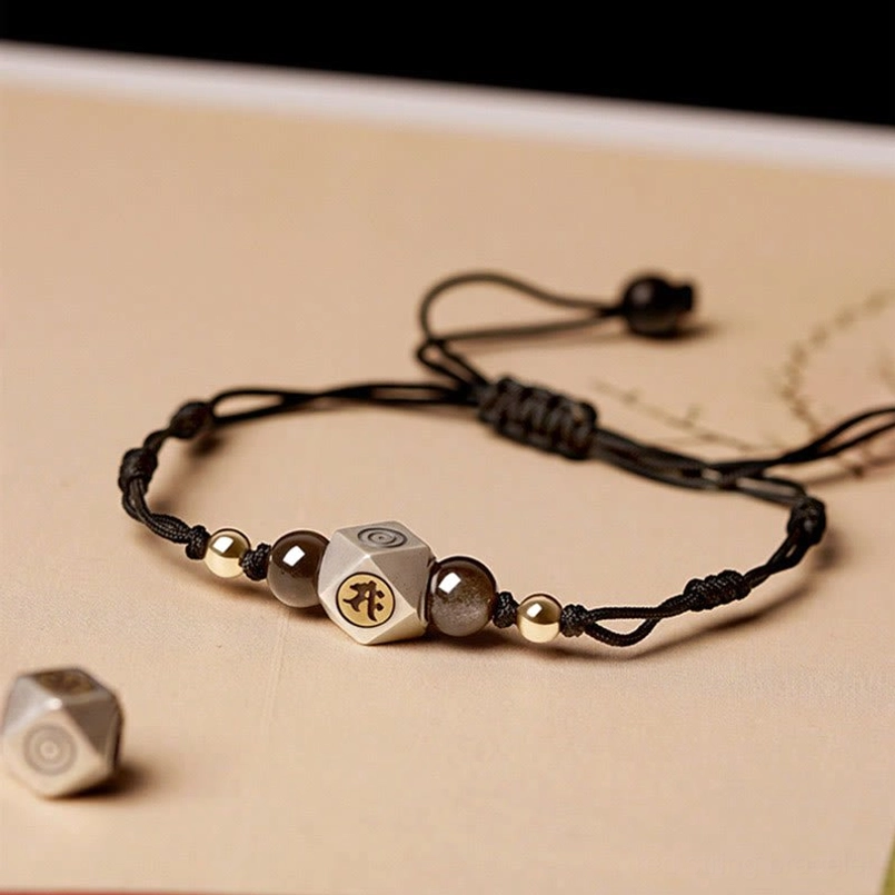 Black braided natal Buddha bracelet with dark stone beads and engraved silver charm