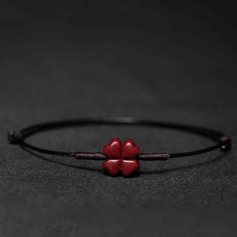 Black cord bracelet with four-leaf clover charm for good luck