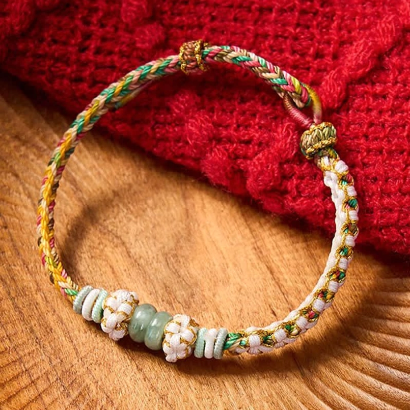 Black Chinese knot bracelet with protective jade and metal accents detail
