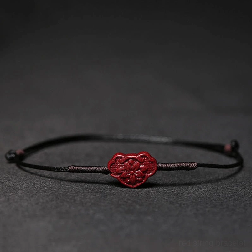 Black cord bracelet with lock of good wishes charm detail