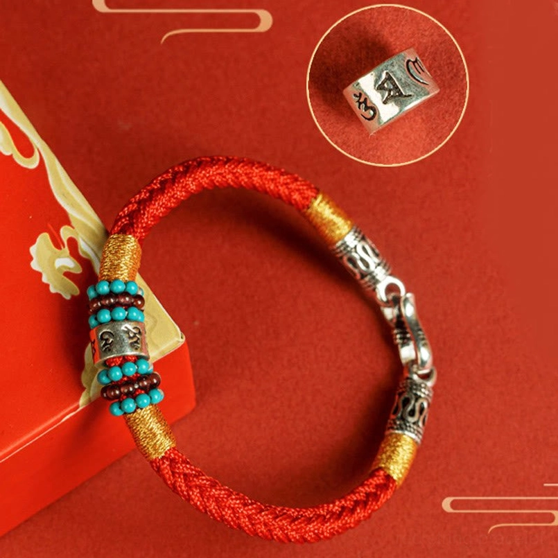 Black string bracelet with Tibetan script silver charm detail shot