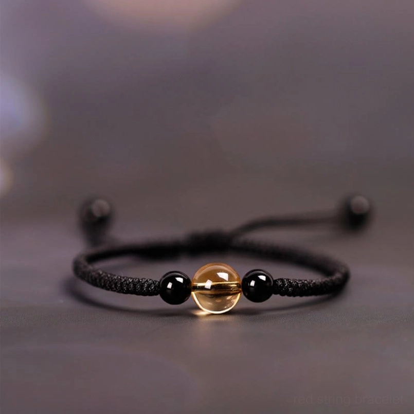 Black cord bracelet with citrine and black obsidian beads three quarter view