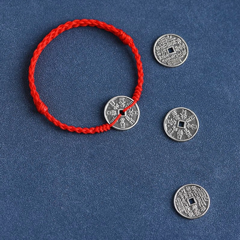 Black woven cord bracelet with antique square-hole silver coin center