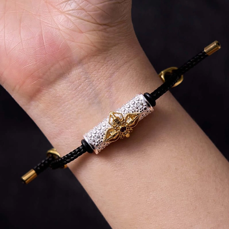 Black string bracelet with colorful enamel flower charm and copper metal base