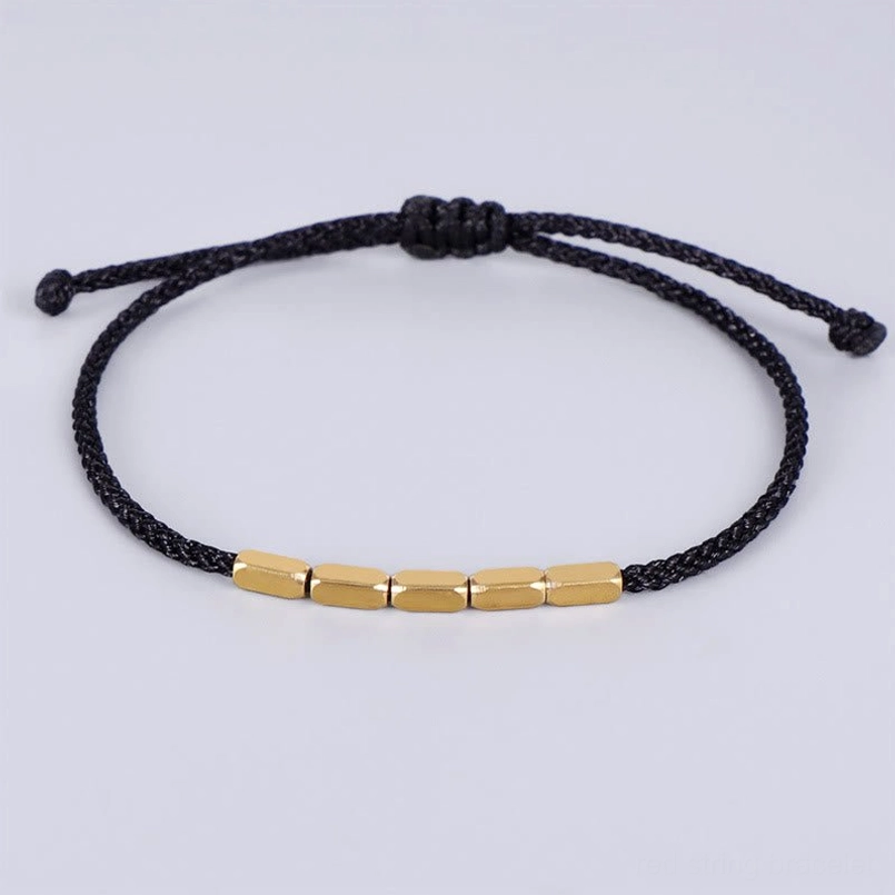 Black braided string bracelet with gold copper cylindrical beads and sliding knot