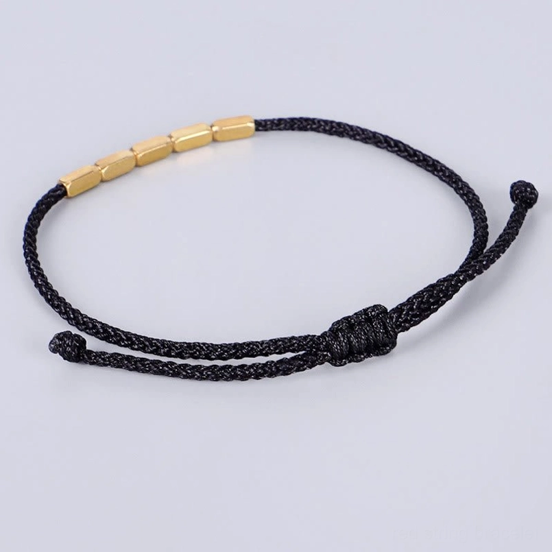 Black handcrafted bracelet with copper beads showing adjustable closure knot