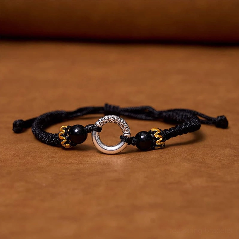 Black woven cord peace buckle bracelet with decorative agate beads close-up detail