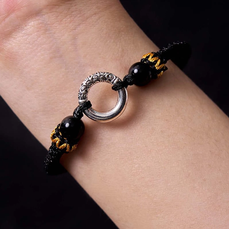 Black braided peace buckle bracelet with dual adjustable pull strings display