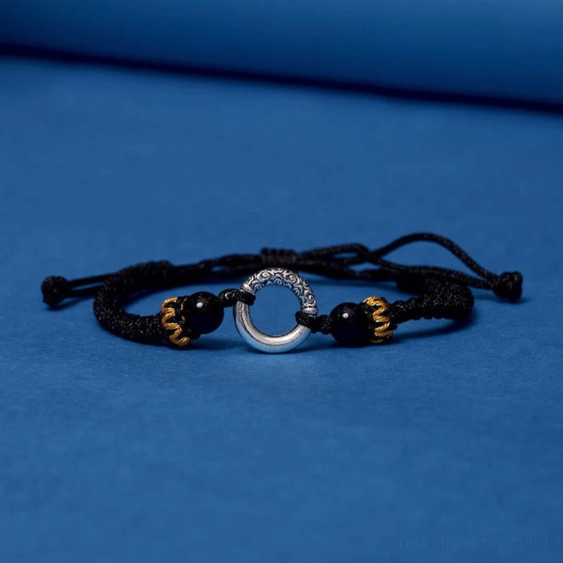 Black string peace buckle bracelet minimalist product photography on studio background