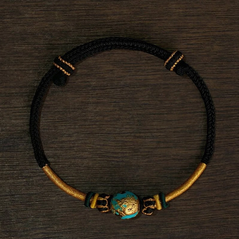 Black string phoenix bead bracelet with carved jade focal point