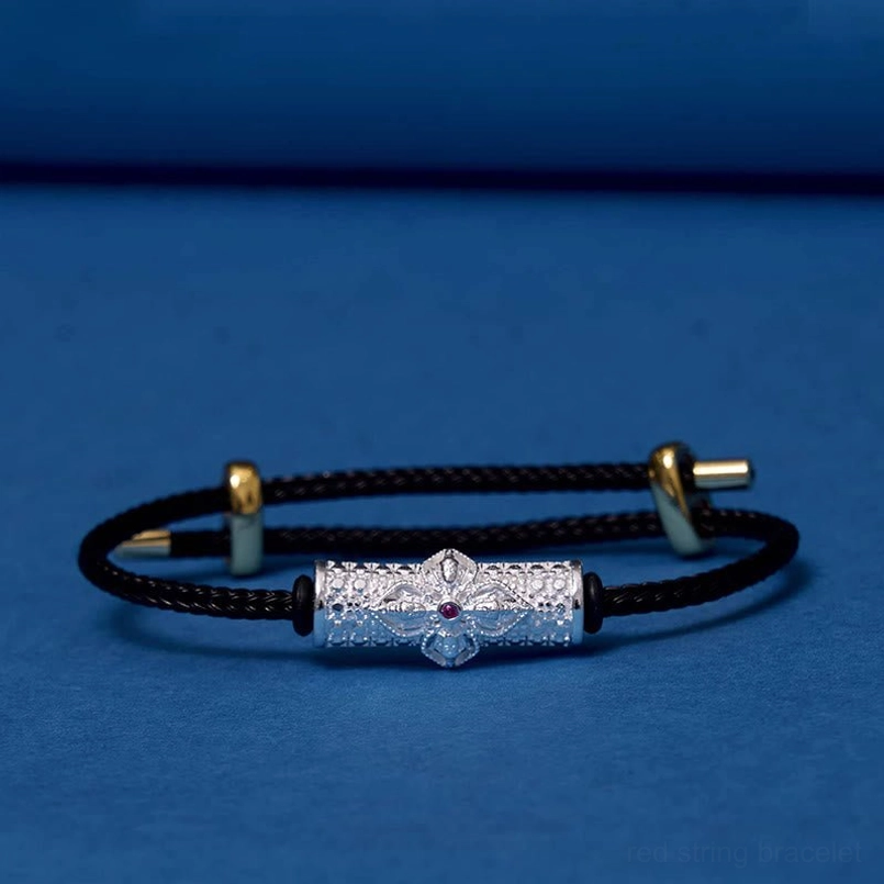 Copper luck bracelet with black braided string and precious metal flower charm