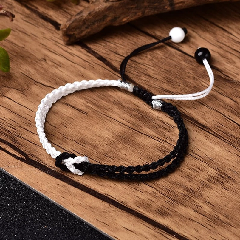 Single black white woven braided healing bracelet with metal adjustment detail