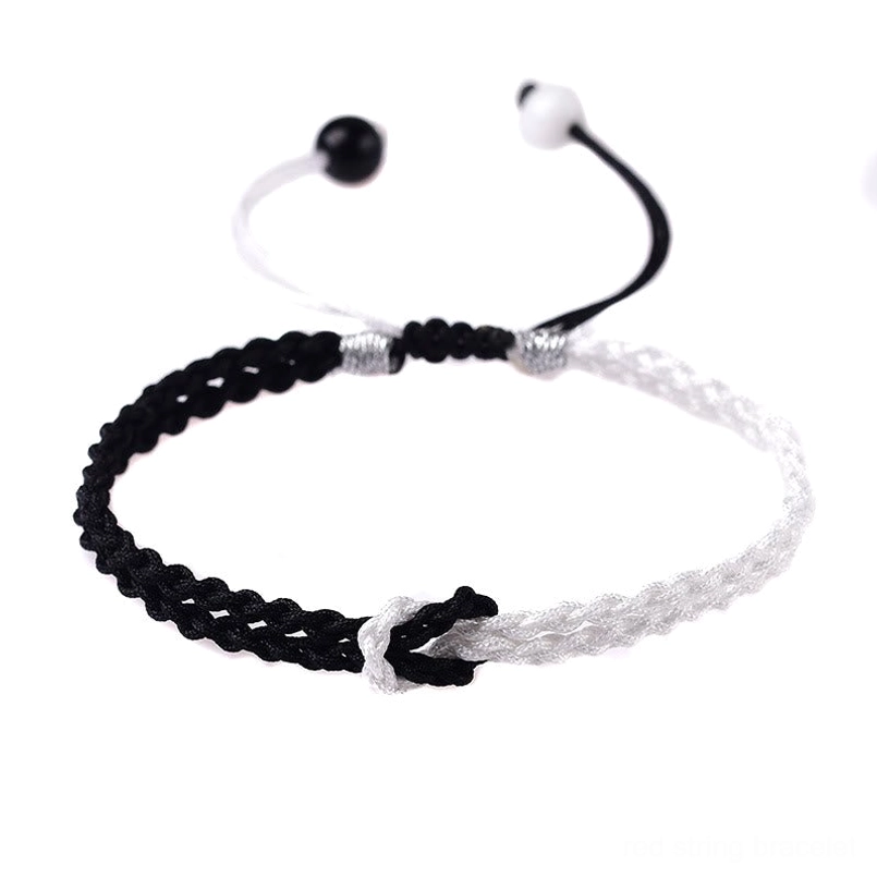 Handmade black white braided healing bracelet overhead close-up color-block design
