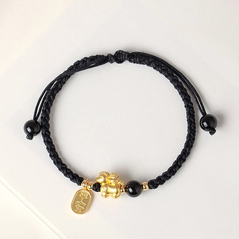 Black woven cord zodiac horse bracelet side view with adjustable knot