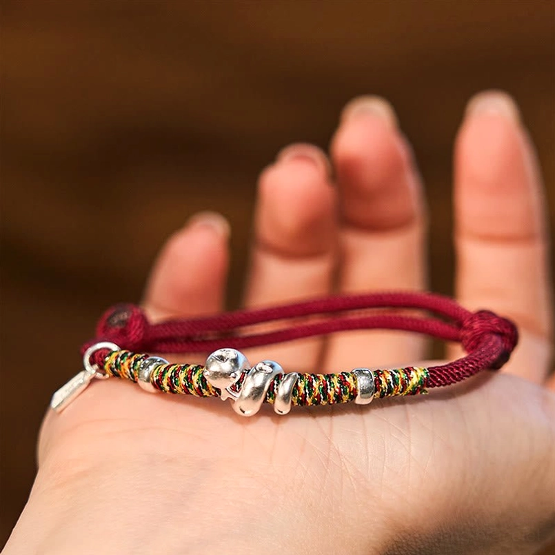 999 Sterling Silver Year of Snake Red String Bracelet closeup held on palm
