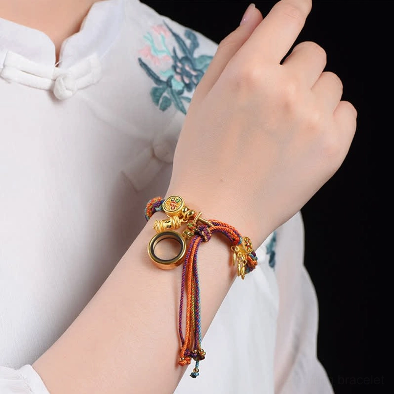 Tibetan red string bracelet worn on woman's wrist close up shot