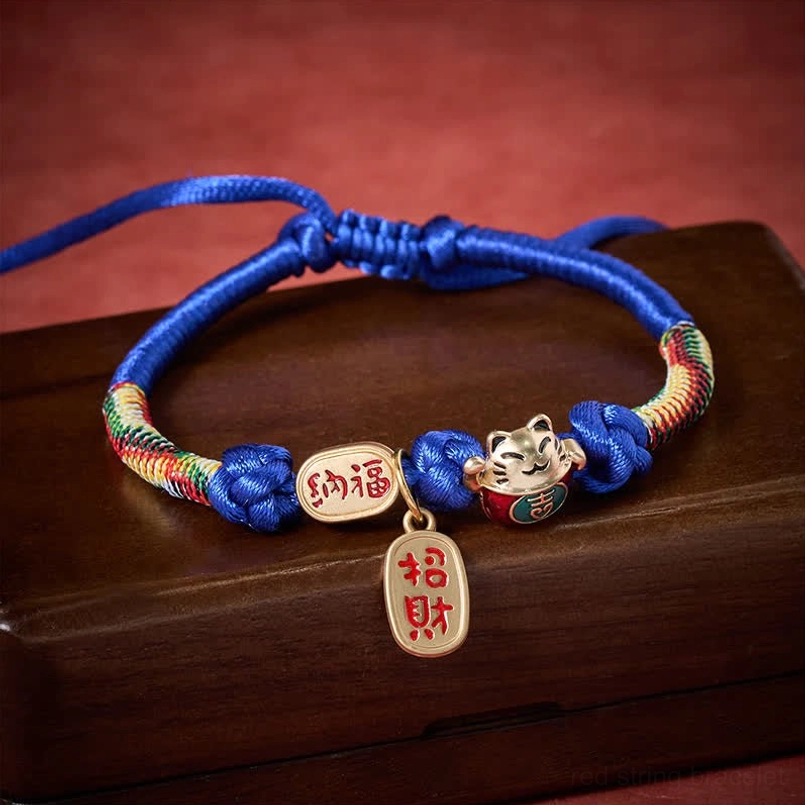 Adjustable blue pet collar with sliding knot and lucky fortune pendant on wooden tray