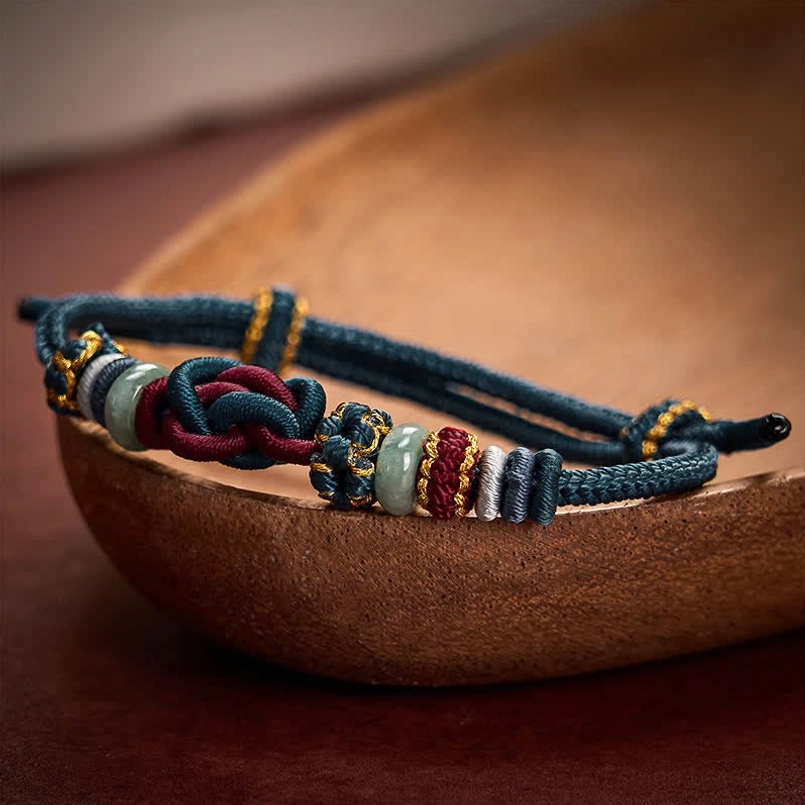 Blue red lucky knot jade bracelet close-up showing dual-tone weaving