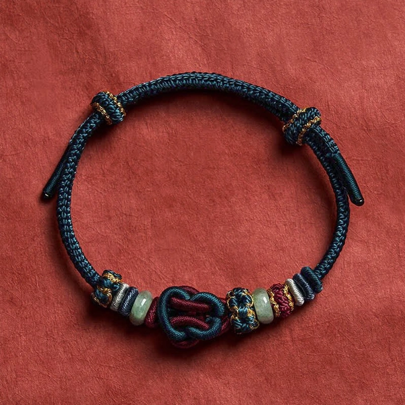 Blue red woven jade bracelet with heart knot design and gold threading