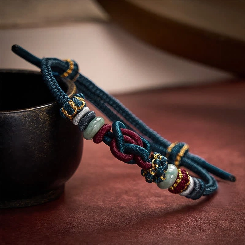 Blue red braided string bracelet showing color variation and adjustable fit