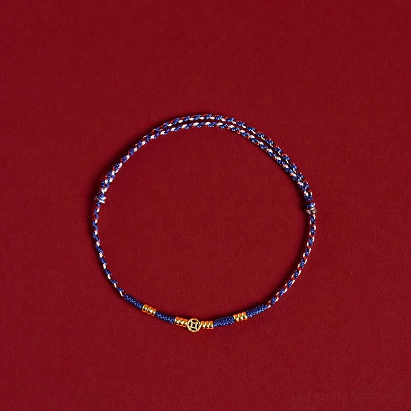 Blue woven braided bracelet with gold decorative beads, top-down flat lay product shot