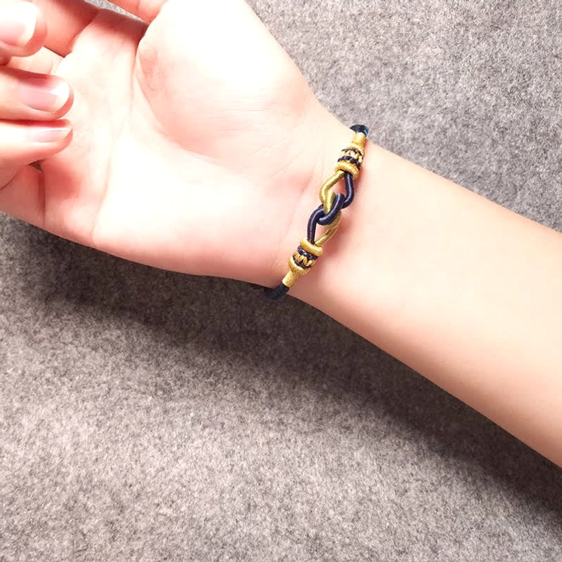 Braided dark blue string bracelet worn on wrist daily wear view