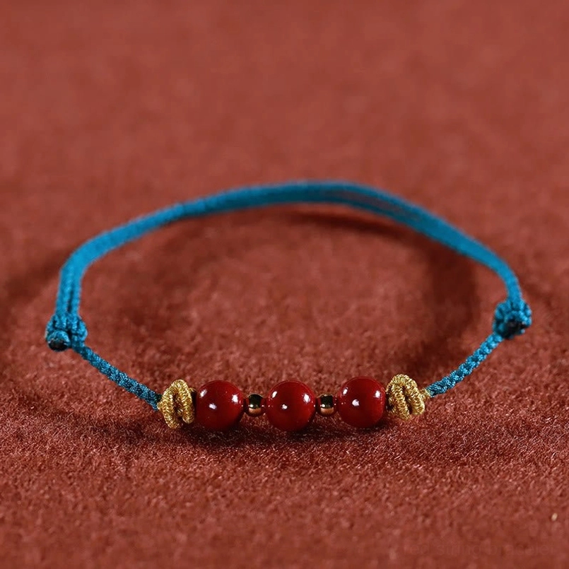 Lake blue cinnabar bracelet front flat view with 3 cinnabar beads