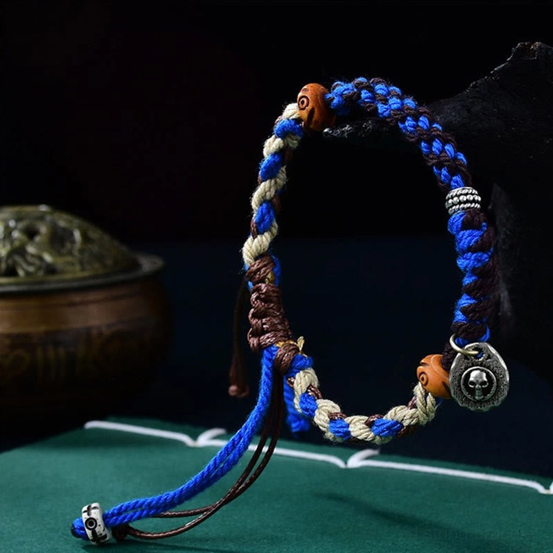 Blue Garuda bracelet side angle view showing woven rope design and adjustable ties