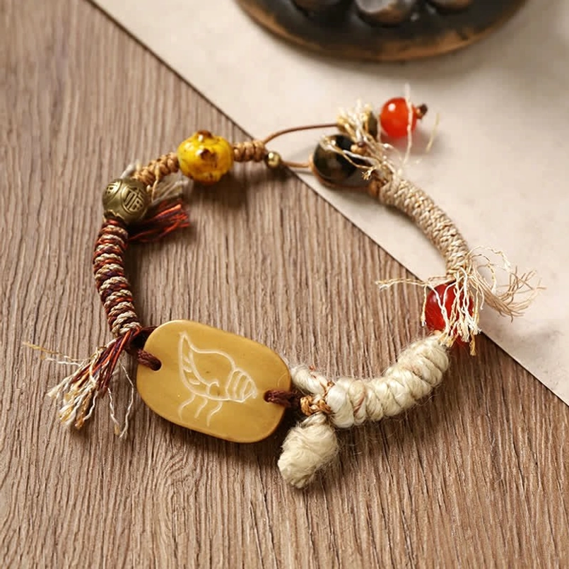 Brown two-tone braided rope bracelet with carved bone Fu pendant and beads