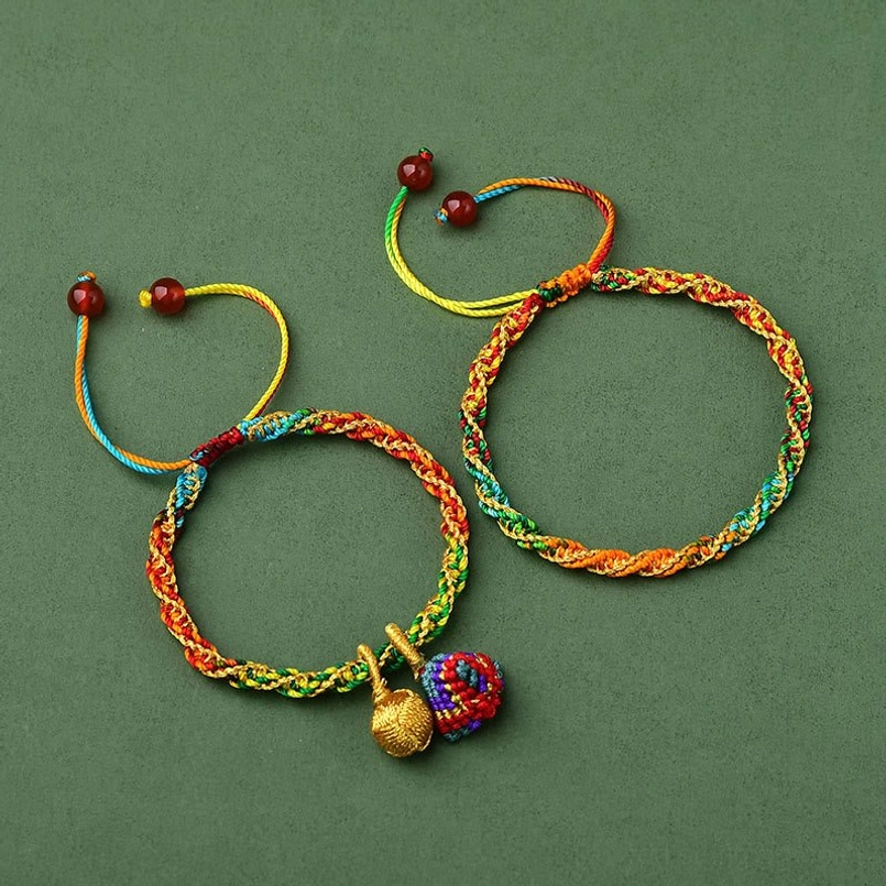 Comparison of two woven festival bracelets one with zongzi charm pendant and one plain style