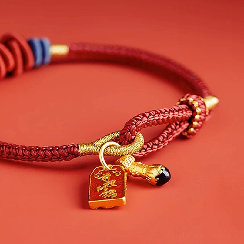 Braided red string koi fish bracelet macro detail spiral knots