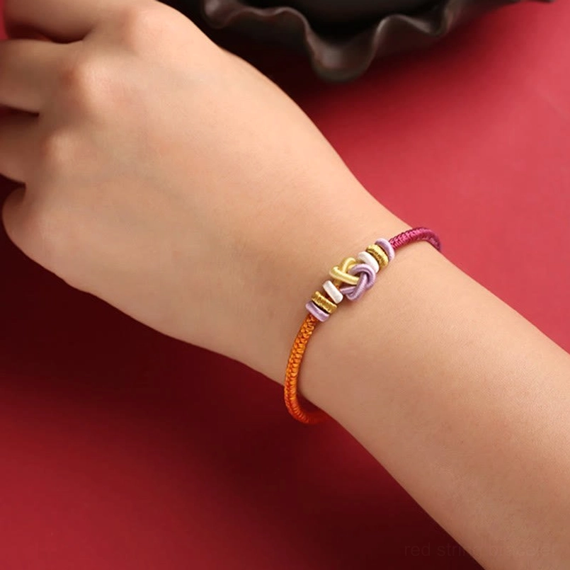 Hand-woven protection bracelet on wrist closeup showing braided thread detail