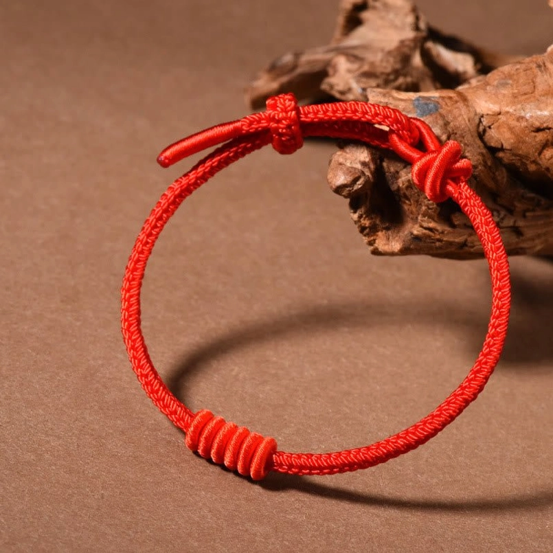 Classic bright red eight stranded red string bracelet flat lay view