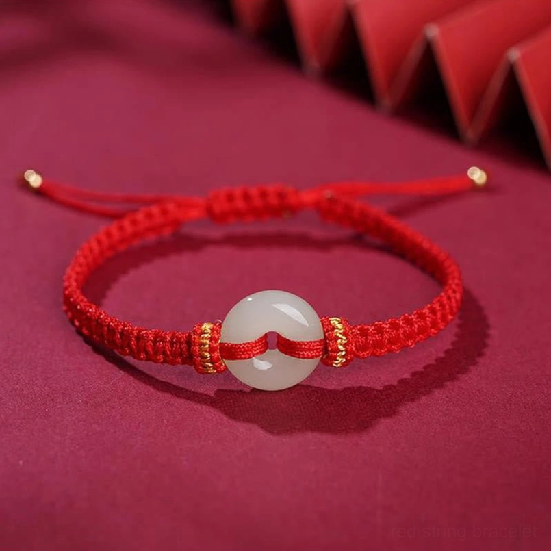 Bright red braided string bracelet with jade peace buckle charm