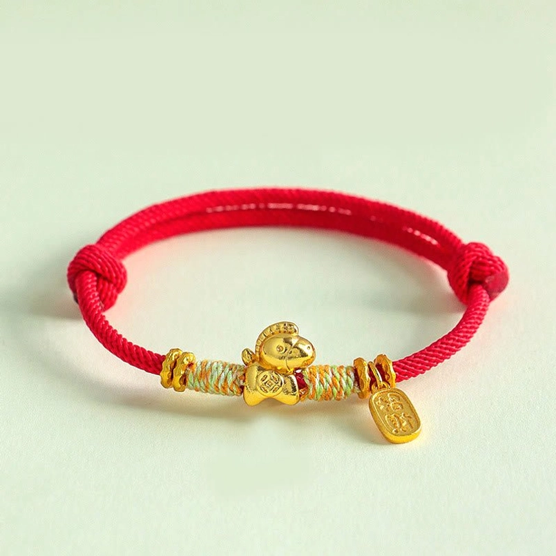 Bright red braided Chinese zodiac horse bracelet with gold charm light green background