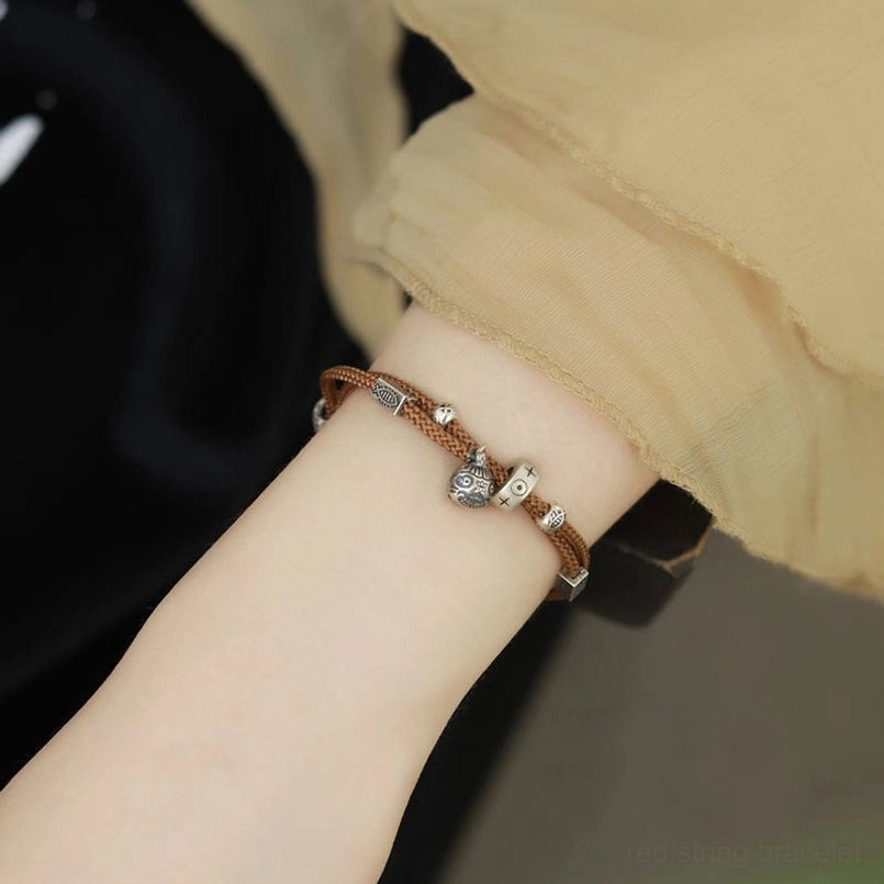 Brown woven string bracelet with 925 silver beads and charm