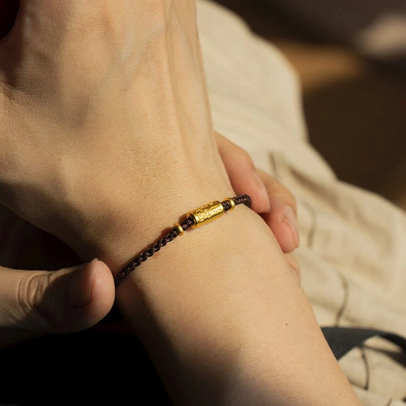 Brown braided lucky bracelet with carved 999 gold central charm