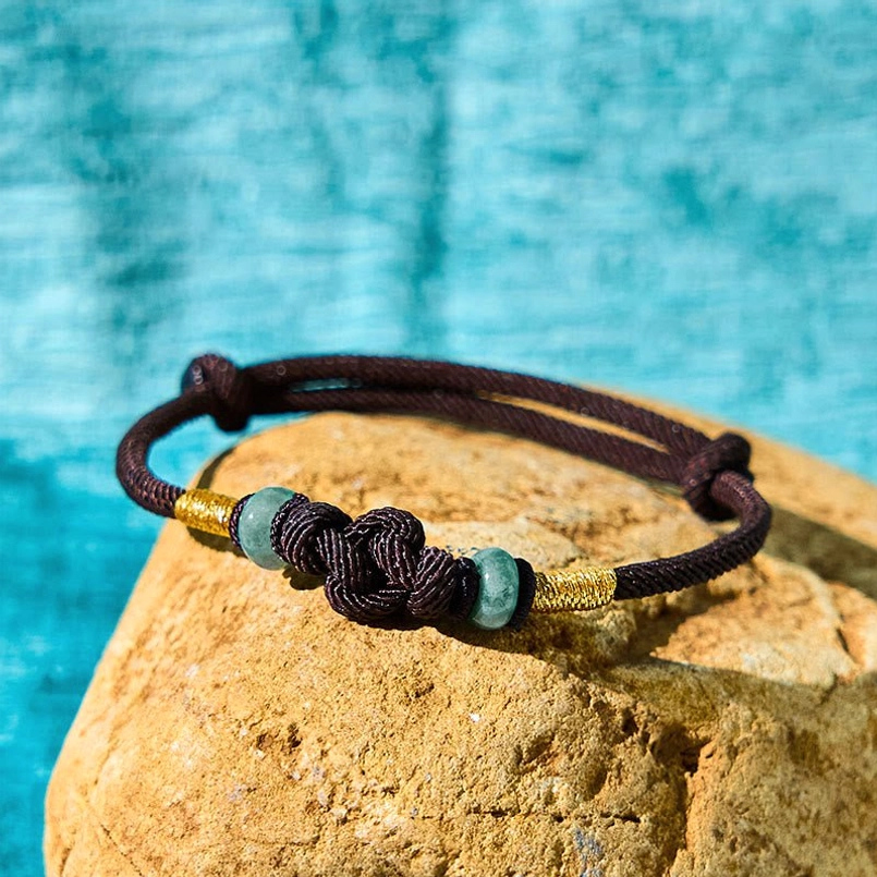 Brown string jade bracelet with matching braided knot and jade bead accents