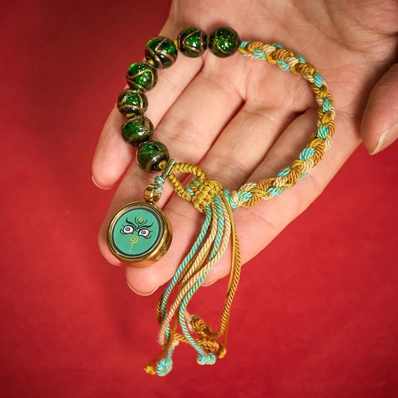 Tibetan liuli glass bead bracelet with Buddha eye third eye pendant detail